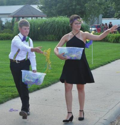 Sophomores Wyatt Wurtz and Elise Uffman were prom servers for the event, and started the prom walk by throwing out beads to go with the Mardi Gras theme.