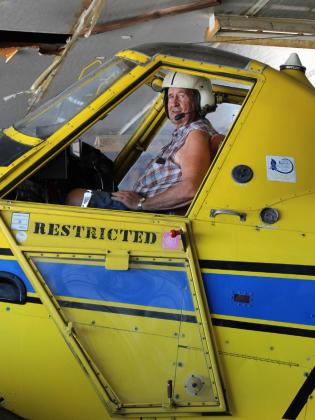 Dean Lovgren, sitting in his spray plane in his hangar, started helping in the aerial spraying business when he was 20 years old and bought JEM Flying Service in 1968. He continues to spray in the area and says he is as busy as he has ever been. Photos by CYNTHIA SCHEER / WCN