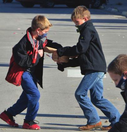 Cope Sorell puts some parade candy into Grady Wurtz’s cowboy hat, which became a very useful space to store their haul. Clifton-Clyde students were spread out along the route to enjoy the parade.
