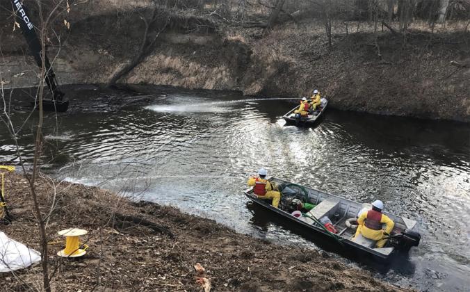 TC Energy personnel used boats to get onto the water surface so they could use low-pressure water pumps to direct oil toward mechanical recovery operations on Mill Creek. This is an EPA photo from Jan. 10.