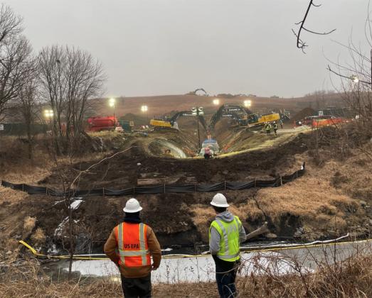 A Dec. 21 photo by the EPA shows on-scene EPA coordinators observing pipeline repair operations from the north bank of Mill Creek, looking south.