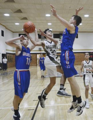Hanover’s Philip Doebele goes up to defend a shot attempt by Linn’s Ezequiel Ruacho.