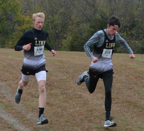 Trent Beier, left, and Isaac Rogge, both seniors at Linn, jog down a hill during the Class 1A regional cross country race on Saturday. They placed 21st and 23rd respectively.