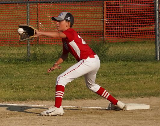 Hanover’s Davis Becker catches a throw to first for an out against Valley Heights in the league championship.