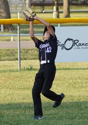 Kalen Martin makes the catch on the run in the outfield for an out against Hanover in the league championship game.