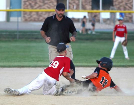 Will Holle tags a Diller- Odell player as he slides into second base for an out for Hanover’s defense.