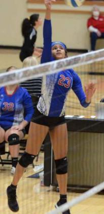 Sophomore Ceegan Atkins follows through on a spike during a state match. She led the team in kills during the tournament.