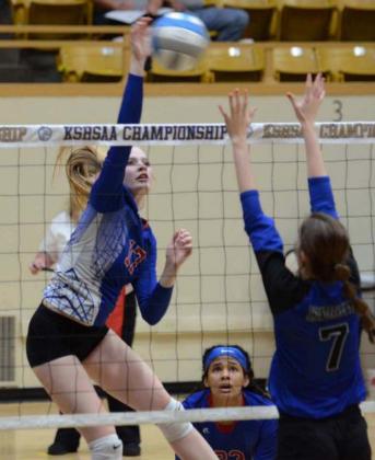 Middle hitter Madison Bruna, a junior, swings over the block of the opposing team at the state tournament. Bruna was also a force at the net on defense.
