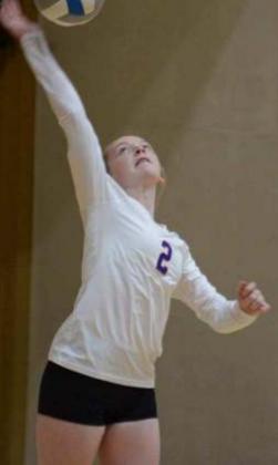Tessa Lohse, a freshman libero, serves the ball at the state tournament. She had several aces in the tourney.