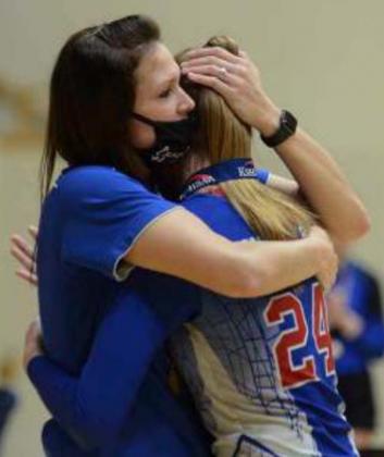 Coach Melissa Holle gives a post-championship hug to her daughter, and sophomore middle hitter, Massey Holle on Saturday.