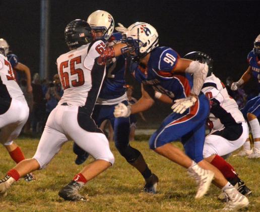 Clifton-Clyde sophomore Seth LeClair blocks against the Hanover rush, including Blake Hynek, right, and Philip Doebele.