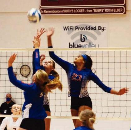 Ceegan Atkins and Massey Holle go up to contest an Axtell spike attempt in the second round of substate.