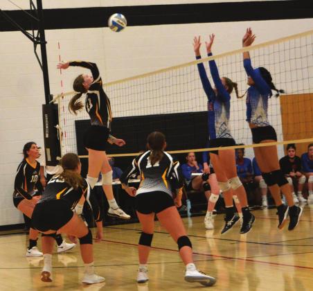 Linn sophomore Ella Thalmann goes up for a spike against Hanover blockers Massey Holle and Ceegan Atkins, while Linn players Sophia Bott, Lindsay Mueller and Kaily Weiche cover.