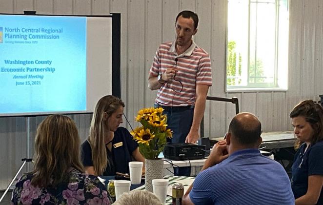 Mark Uhlik spoke during Washington County Economic Partnership’s annual meeting last week while director John Bruna looked on, above, and Dustin Rogge gave a presentation during the meeting, below.