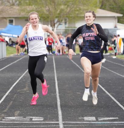 Sevy Wurtz, right, and Anna Jueneman, sprint to the finish line in the 100 meter dash for a photo finish. Wurtz edged Jueneman out in the race.