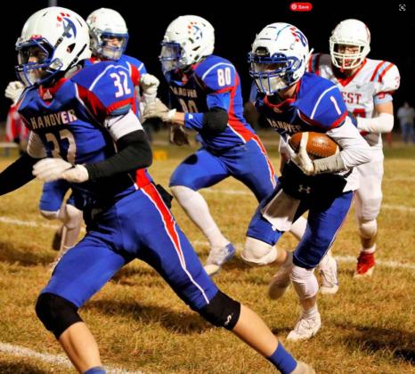 Quarterback Jacob Jueneman takes off on a run behind the blocking of Philip Doebele (#32) during Friday’s playoff game.