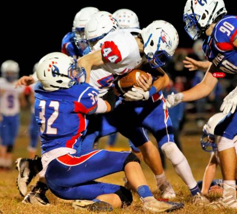 Philip Doebele, left, gets into the backfield to take down the Axtell ball carrier. Braelen Stallbumer makes an open field tackle for the Wildcats. Both players are juniors for Hanover, which advanced in the playoffs with a commanding win on Friday.