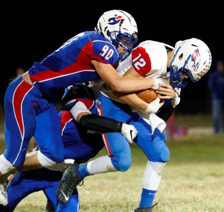 Senior Blake Hynek helps corral an Axtell running back during Hanover’s win over the Eagles on Friday.