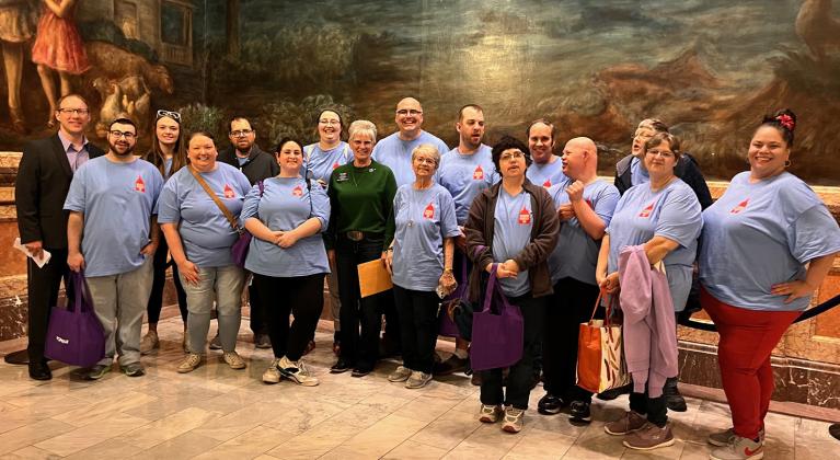 Twin Valley consumers visited the State Capitol on March 14 delivering hand written thank you notes and hugs to Representative Lisa Moser for her support of IDD legislation. At left is Mike Peschel, CEO of Twin Valley Developmental Services, Inc., their tour guide for the day.